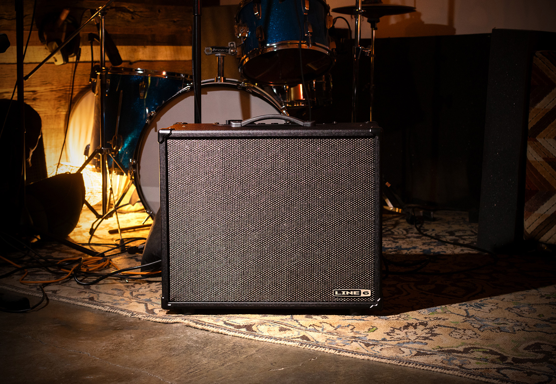 Powercab CL 212 on rug infront of drumset.