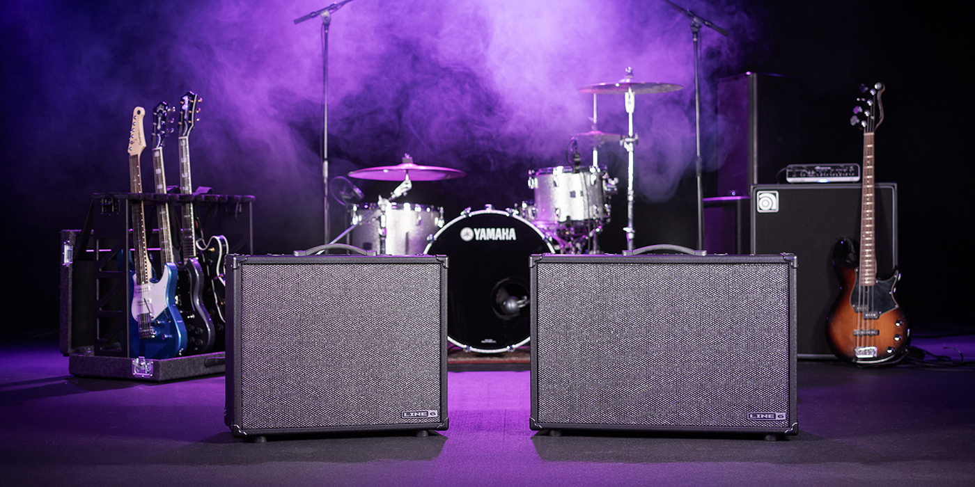 Powercab CL 212 and Powercab CL 112 displayed on stage with guitars, drums and bass and purple lit haze.